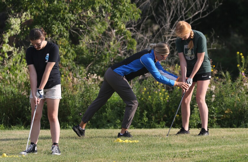 jhs girls golf practice coach tracy helping 081122.jpg