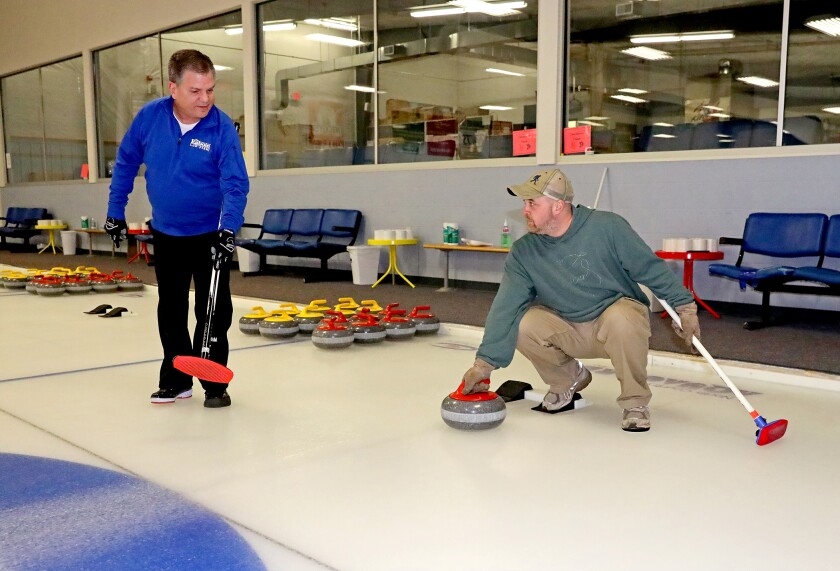 Several people from the Brainerd Dispatch get a curling lesson at the Fran Holden Curling Arena.