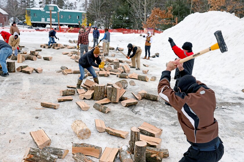 Participants take up axes for a Nisswa Winter Jubilee wood-splitting contest.