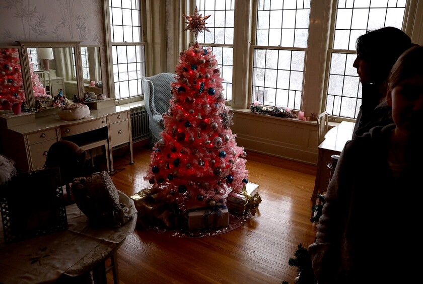 A pink tree is the centerpiece in a bedroom at Glensheen Mansion while students from SHS walk by during a tour