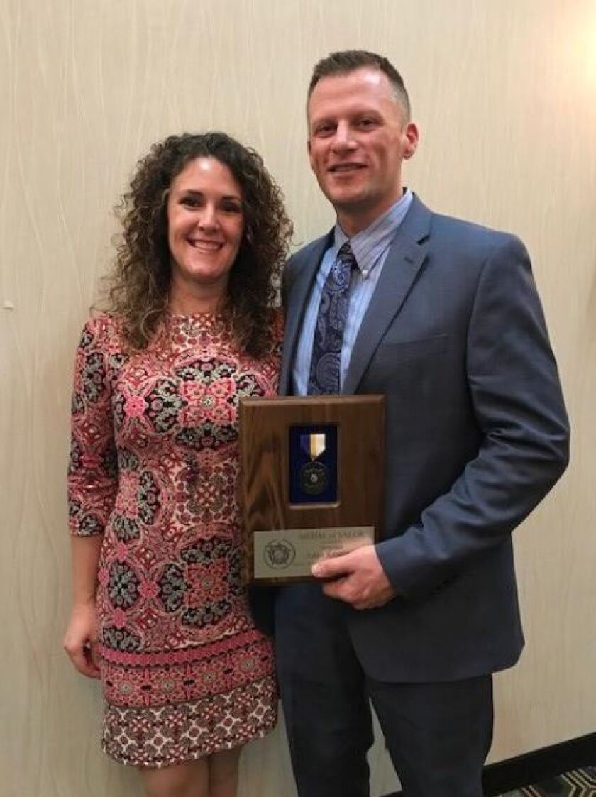 Crow Wing County Sgt. Adam Kronstedt received the Medal of Valor from the Minnesota Sheriff's Association for his efforts to save a drowning victim in June. Kronstedt is pictured with his wife, Charlene. Submitted Photo