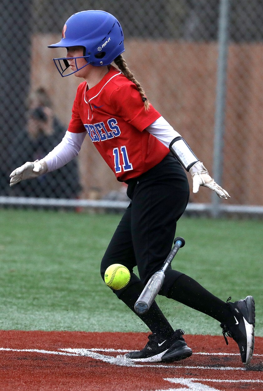 Moose Lake’s Lily Kahara (11) drops her bat as she bunts the ball