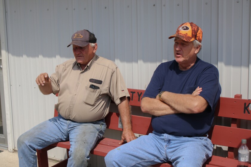 Left to right, Harv Lindgren, a farmer, and Steven Anderson, a former municipal judge, sit outside the Kulm Tasty Treats & Care to talk on Aug. 13, 2024, in Kulm, North Dakota. .jpg
