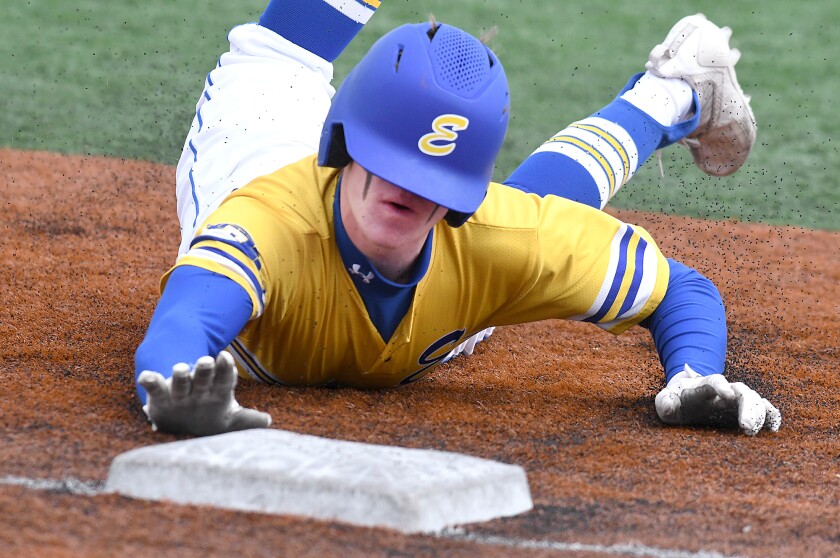 Even with his helmet falling over his eyes, Esko’s Cale Haugen (5) slides safely into third base