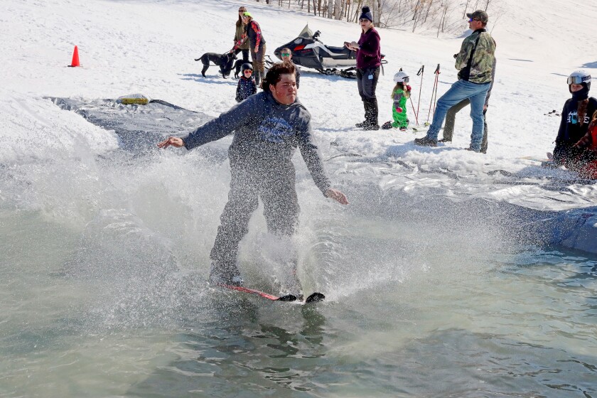 Skiers and snowboarders participate in the water skip at Mount Ski Gull on Saturday, April 8, 2023, for the end of the season.