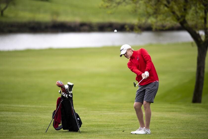 Cardinals golfer Aden Jacobson hits the ball down the fairway at Eagle Creek Golf Course while competing in the the boys varsity conference championship on Friday, May 20, 2022.