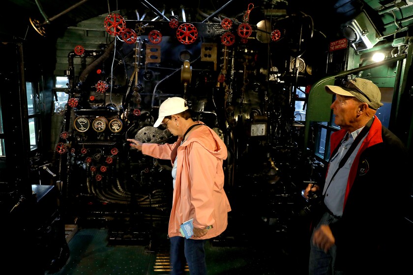 Cruise ship passengers Cathy and Lenny Tout, of Panama City, Florida, look inside a locomotive at the Lake Superior Railroad Museum