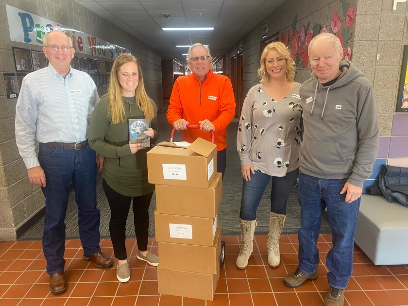 Photo of five people with boxes of dictionaries