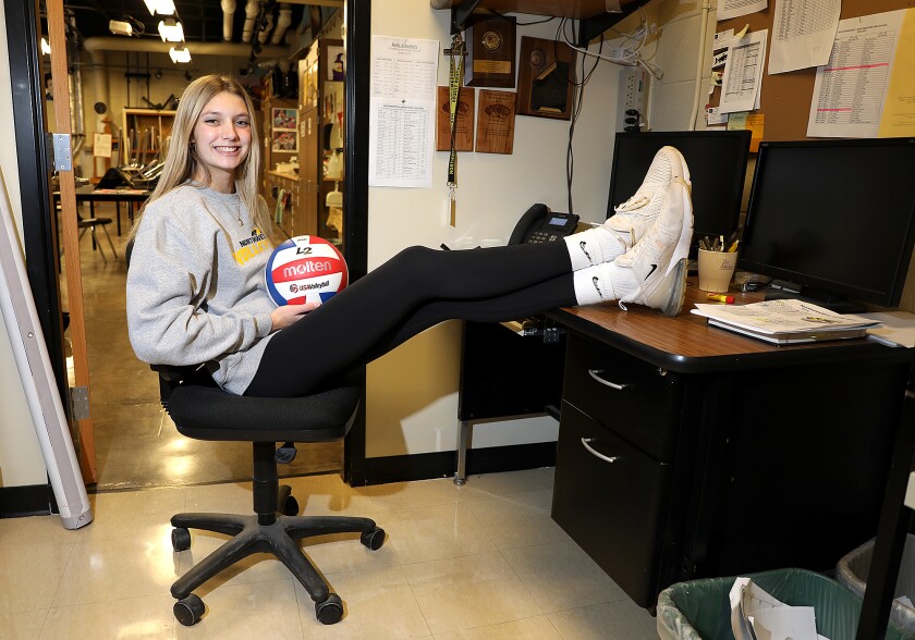 Northwestern’s Brynn Hessel sits with her feet up at her dad’s (and head coach) desk in the art room at NHS