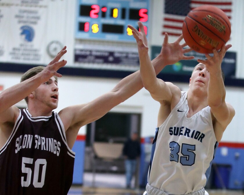 Solon Springs' Isaiah Kastern (50) battles for a rebound with Superior's Drew Eisel (35).