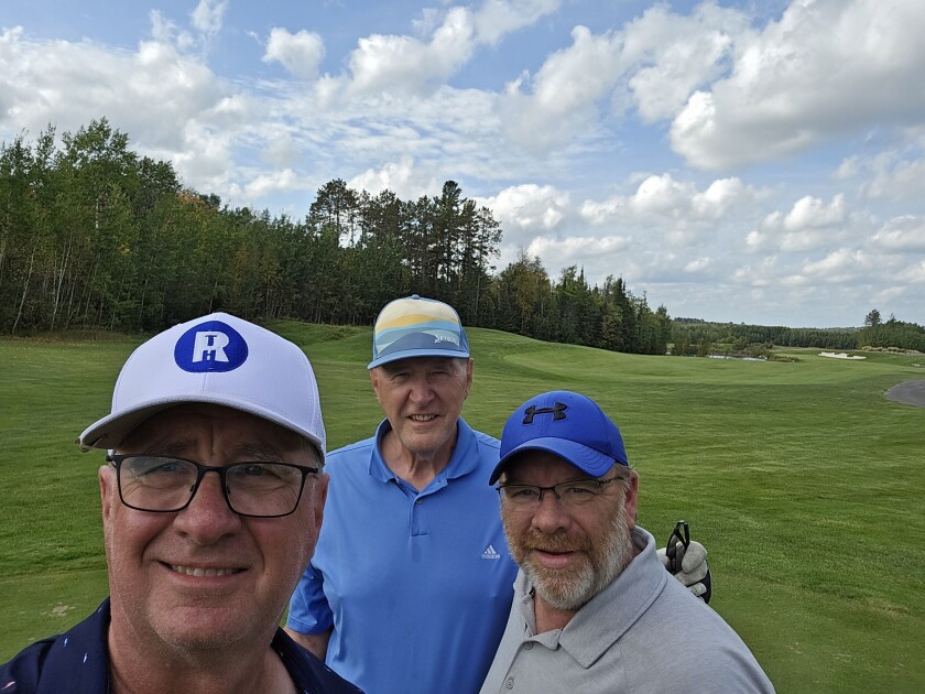Roger Houselog, left, Dr. John Gorton and Darrel McFedries take a break from golfing the Wilderness at Fortune Bay last September during the "Up North Golf Trip."