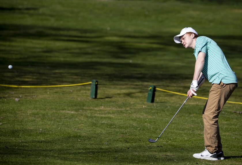 Mark Arnold of Community Christian School hits the ball on the putting green during a Camden Conference boys and girls golf meet at Valley Golf Course Thursday, May 5, 2022, in Willmar.