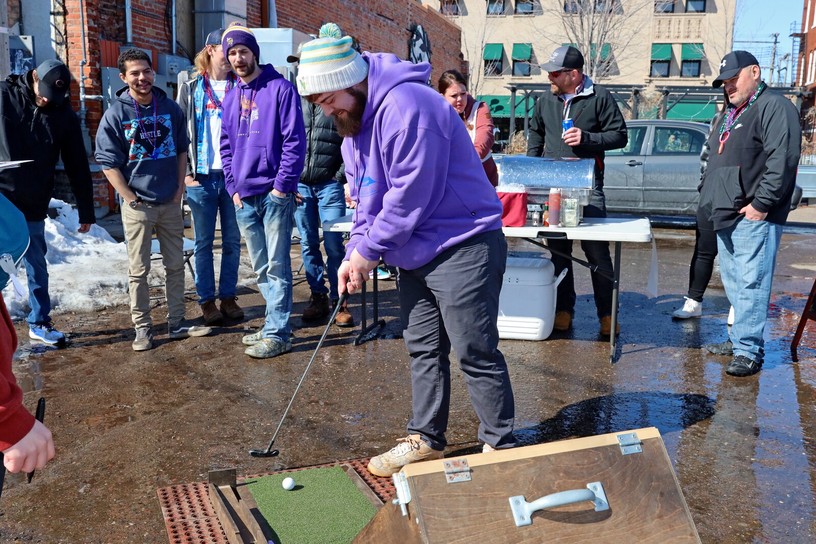 People putt at Sage on Laurel's Skee-Ball themed mini golf hole in the parking lot Saturday, April 1, 2023, during the 16th annual Downtown Golf Spring Open in Brainerd.
