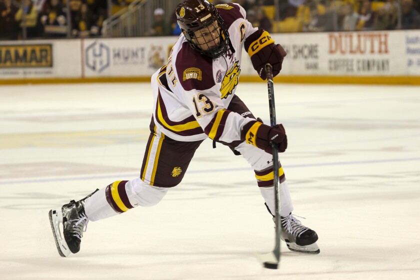 College hockey players play game in indoor arena
