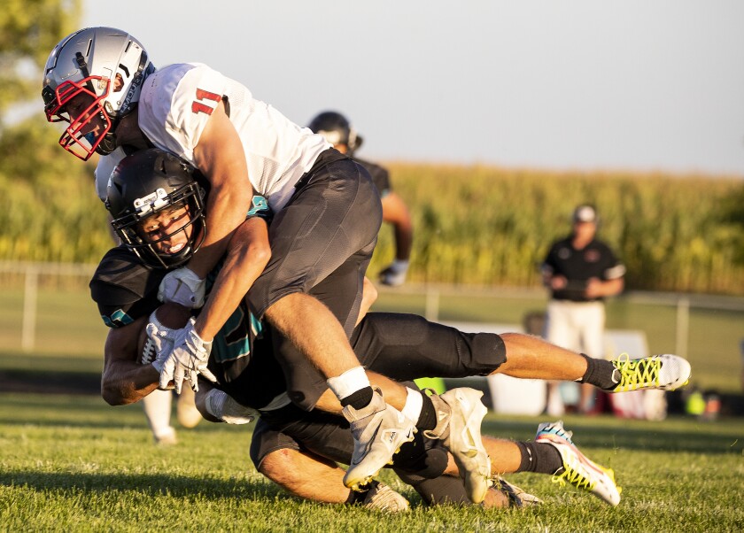 ACGC junior Jevon Williams is brought down by sophomore Hudson Vosika of BOLD during the opening game of the season in Grove City on Friday, September 2, 2022.