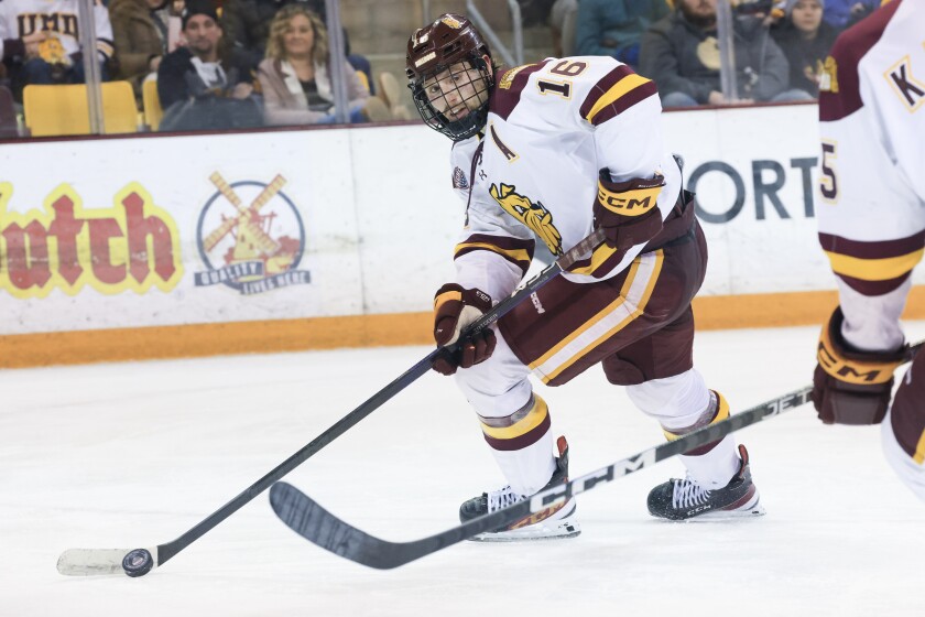 college men play ice hockey