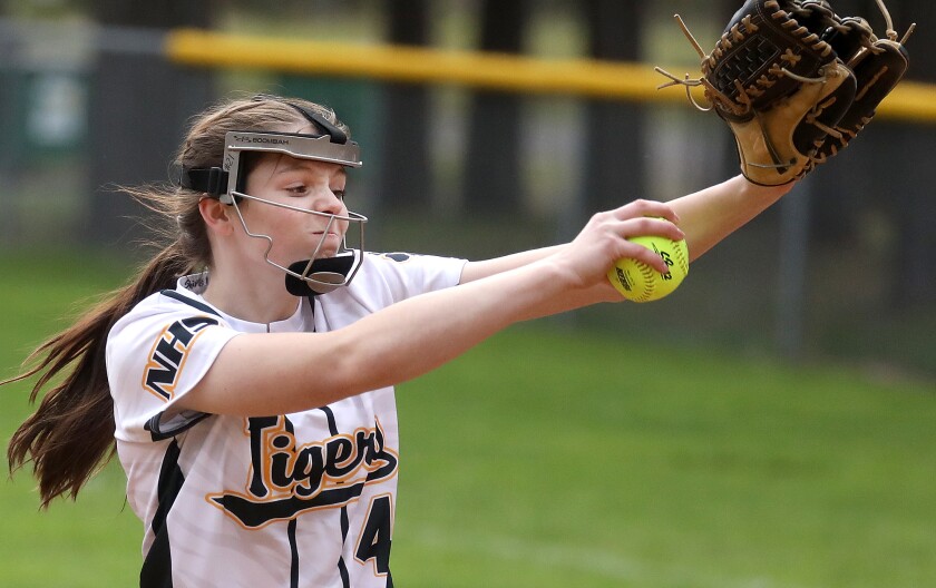 Northwestern’s Ellie Peterson (4) gets into her wind up