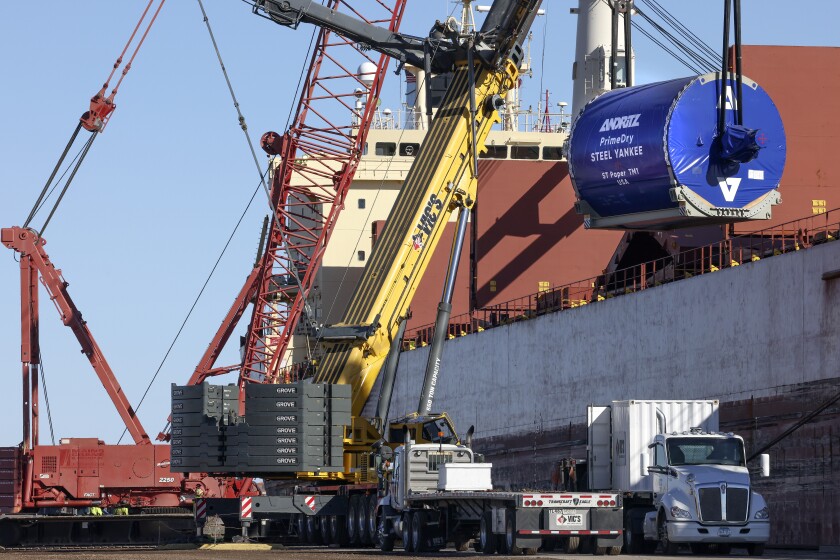 Cargo is unloaded from a ship.