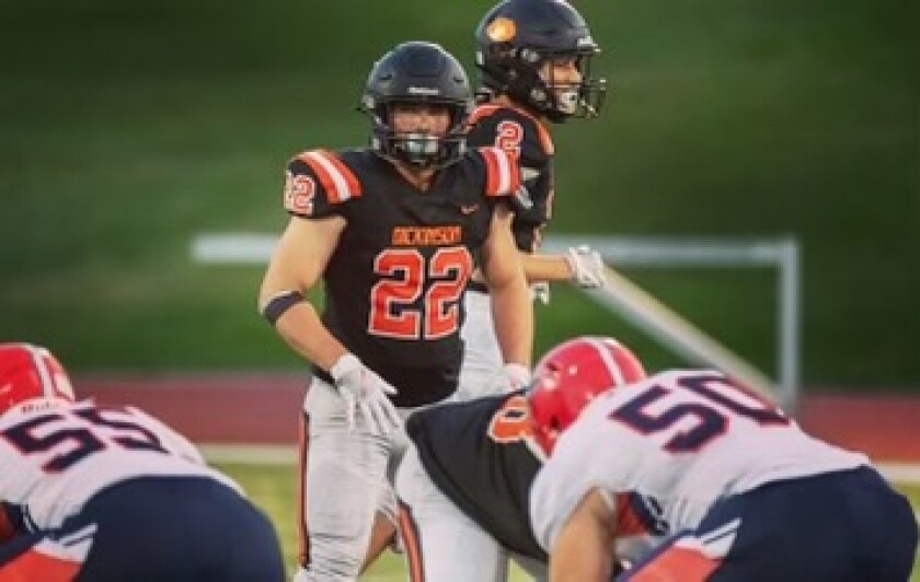 Lukas Mavity, pictured as No. 22 playing football, is a school athlete at Dickinson High School.
