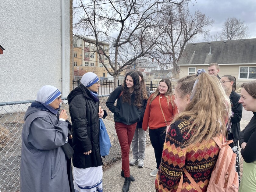 Trinity senior Brooklyn Berger, center, speaks to nuns at a nuns race she helped organize earlier in 2022.