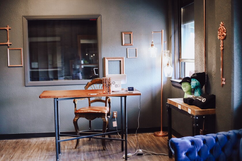 The lobby of a store with copper furniture and décor.