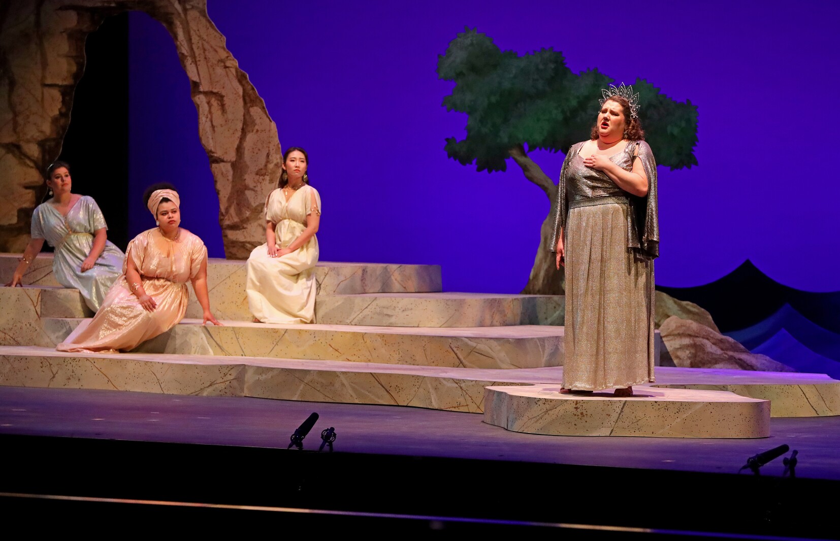 Actors perform on stage.