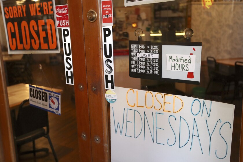 Closed sign in a restaurant window.