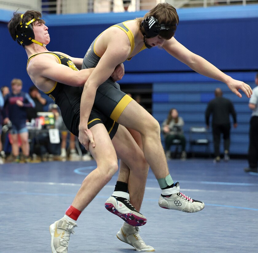 Wrestler tosses opponent.