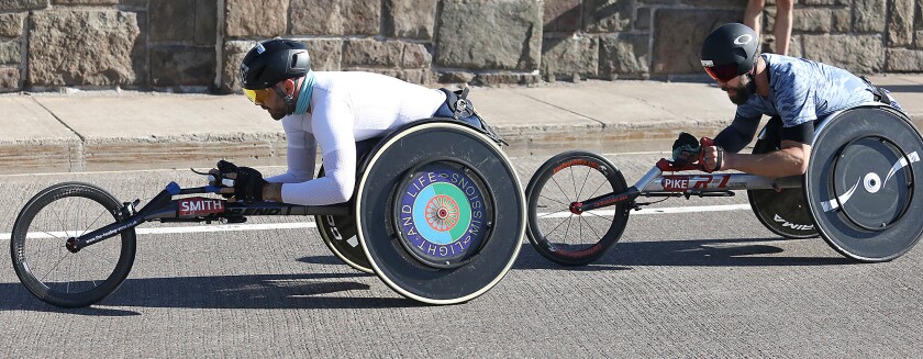 Johnboy Smith, left, holds a slight lead on Aaron Pike as the two roll over the Lester River Bridge