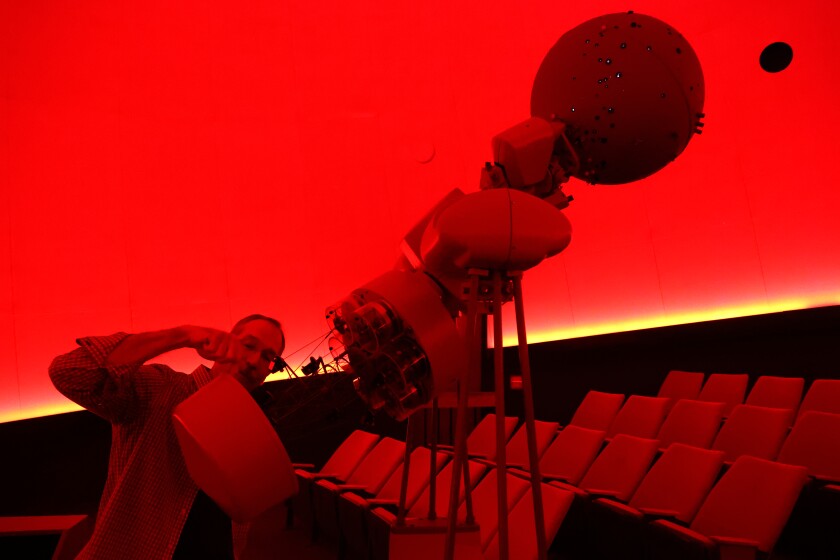 Man shows off components of star projector