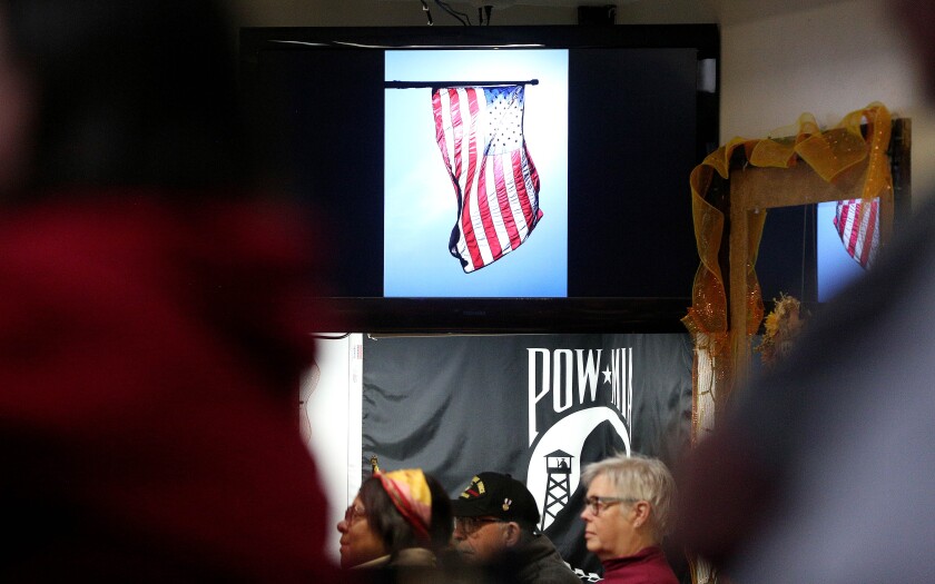 An image of the American Flag shown on a television screen at a Veterans Day ceremony.