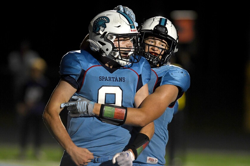 Superior’s Carson Gotelaere (9) is congratulated by Lucas Williams (16) after his first rushing touchdown of the game