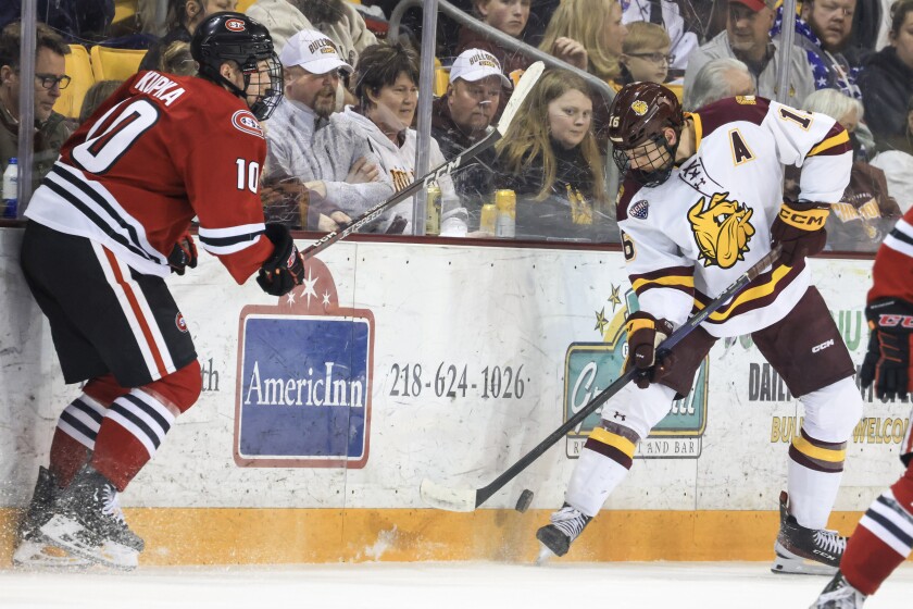 college men play ice hockey
