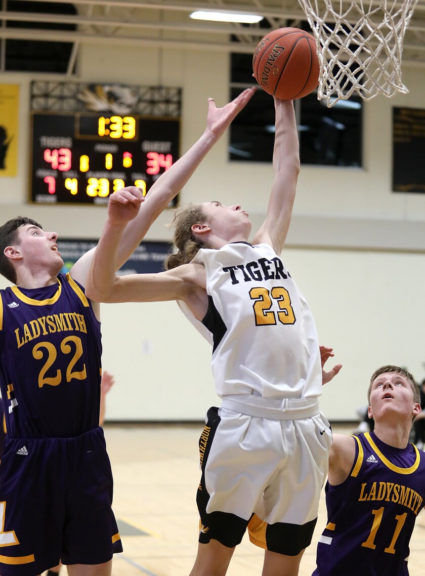 Northwestern’s Grady Gustafson (23) rips down a rebound