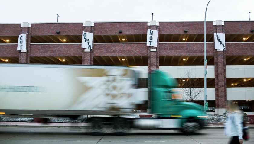 UND students draped banners across the western side of the parking garage reading "Cut Admin Not Sports" early Friday morning. (Jesse Trelstad/Grand Forks Herald)