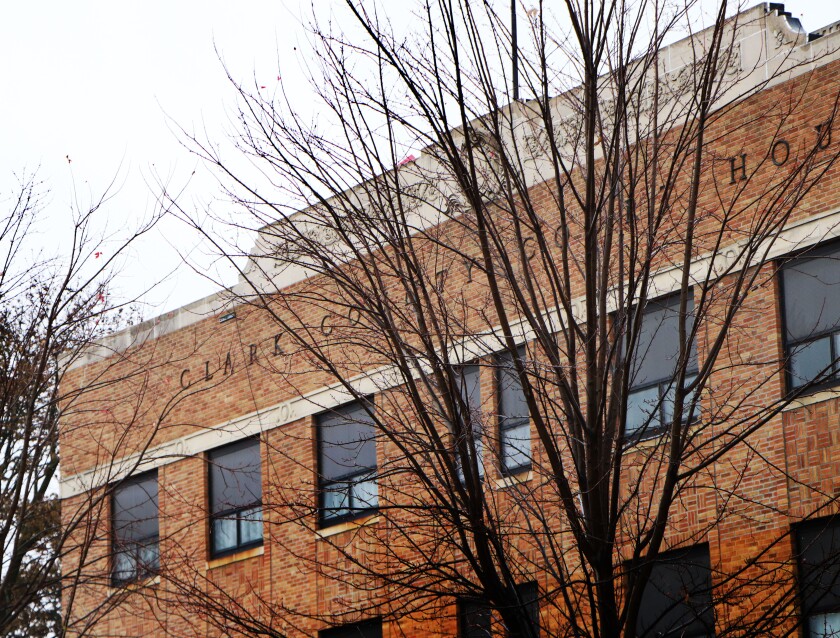 The Clark County, South Dakota, courthouse stands on a gray day in November, amid trees that have lost their leaves.