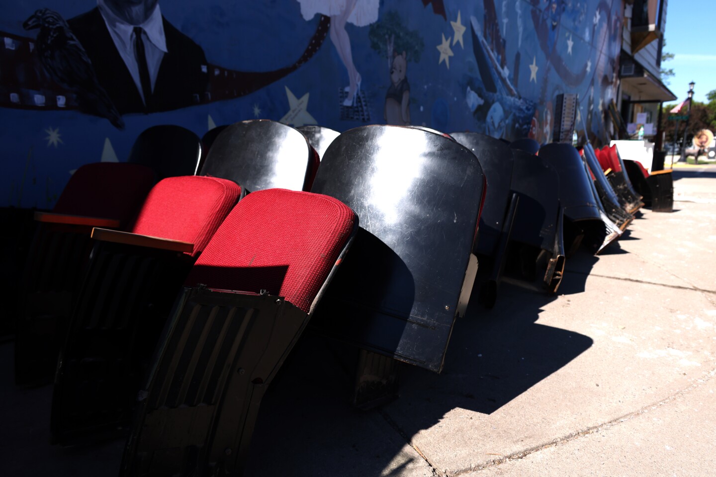Rows of flood damaged theater seats outside