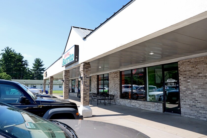 Storefront of Sanchez Burrito with cars parked out front