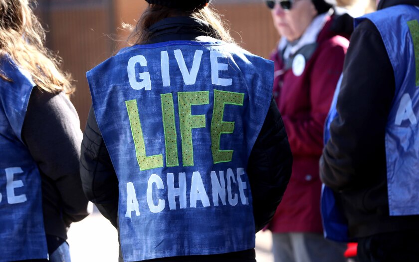 clothing that reads Give Life A Chance