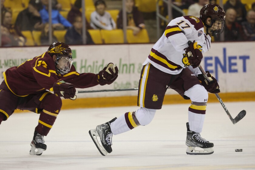 College hockey players play game in indoor arena
