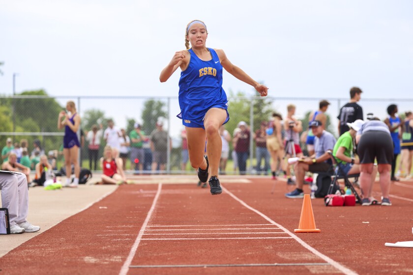 Athletes compete in track and field events at outdoor stadium