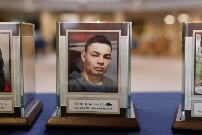 A plaque and candle with a portrait of Elder Hernandez Castillo.