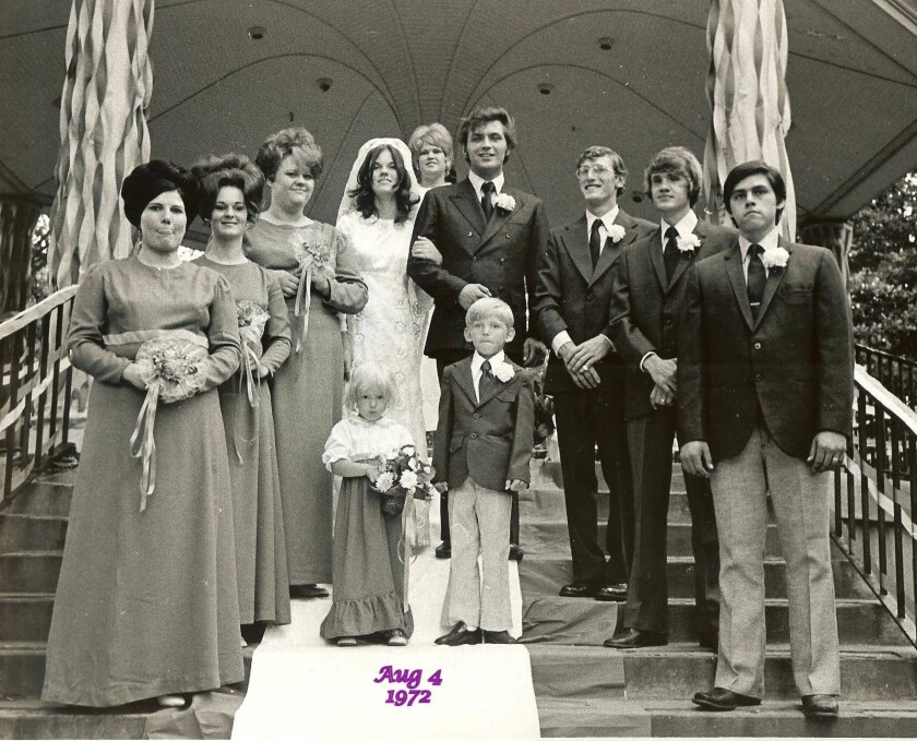 A young couple is surrounded by bridesmaids and groomsmen during a wedding in 1972 at Fargo's Island Park
