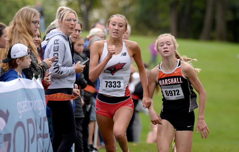 Willmar sophomore Erin Eilers, left, runs by Marshall's Taleigha Bigler near the finish line at the Willmar Invitational on Saturday, Oct. 1, 2022 at Eagle Creek Golf Club in Willmar.