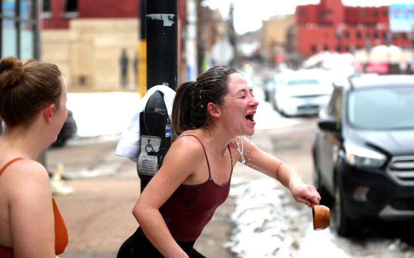 A woman reacts to dumping cold water on her head