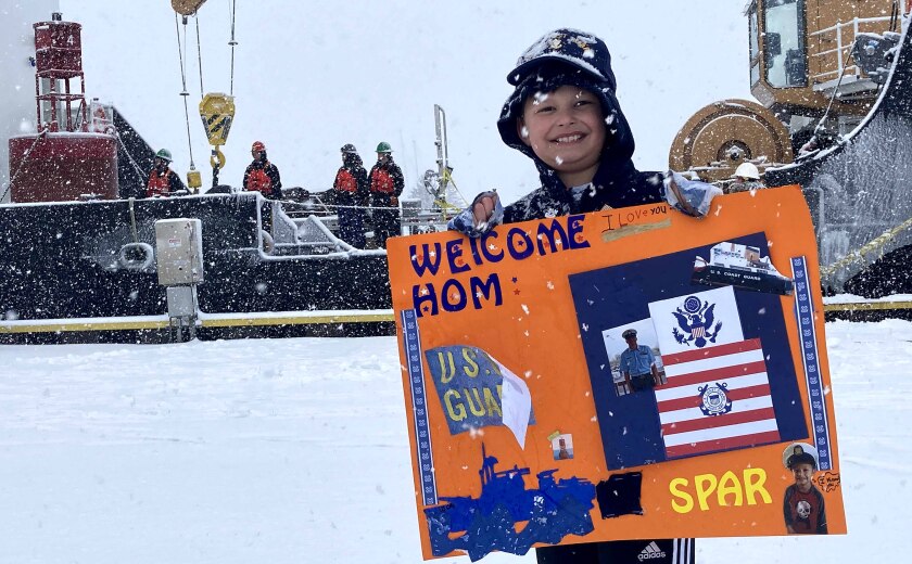 boy holds up sign