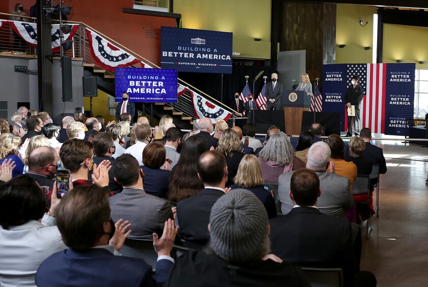 First Lady Dr. Jill Biden, center, addresses the crowd while on stage with President Joe Biden, left, and Gordy Smith