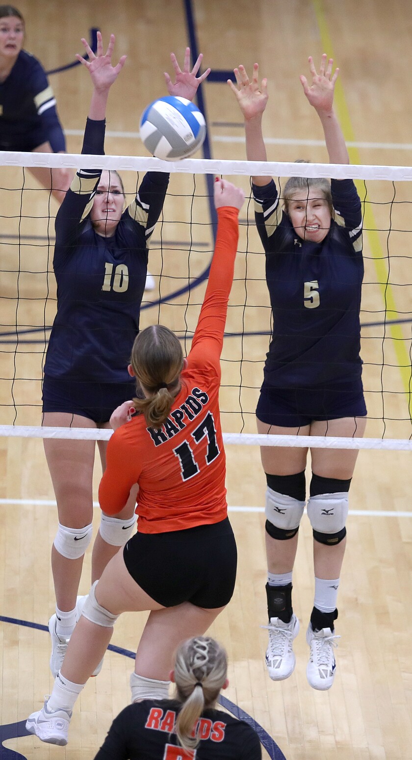 Hermantown’s Zoe Bergerson (10) and Emilie Rish (5) try to block a shot by Grand Rapids’ Peyton Skelly (17)