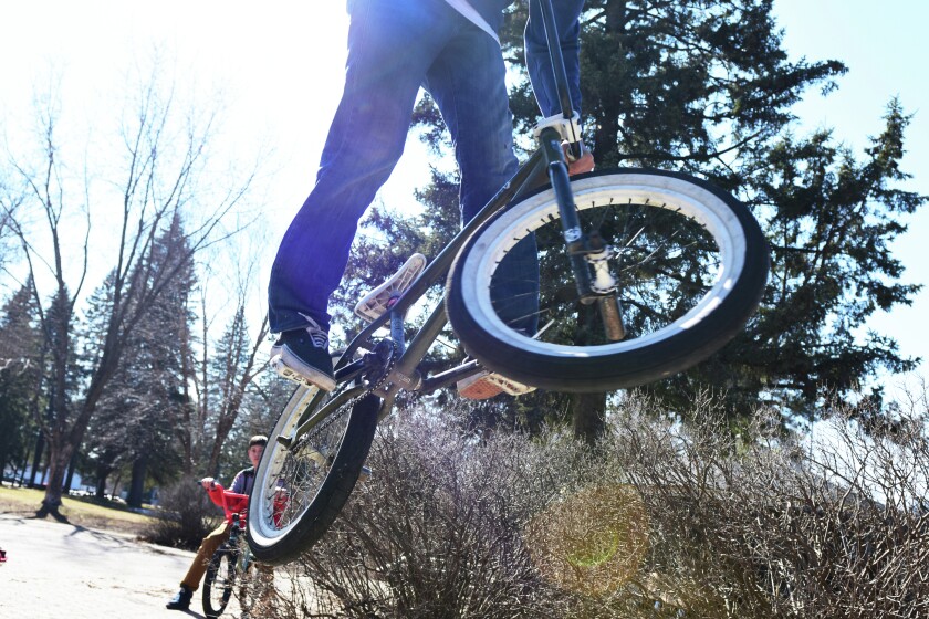 Makail Schroeder jumps his bike in Gregory Park Thursday. (Brainerd Dispatch/ Steve Kohls)