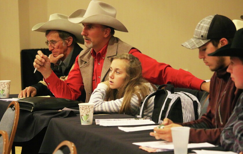 Jason Schmidt of Medina, N.D., a former North Dakota Stockmen's Association president, makes a point during policy debates while his daughter, Madelyn, listens. Photo taken at the group's annual meeting on Sept. 23, 2016, in Minot, N.D. Forum News Service/Mikkel Pates